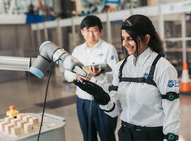 Sharan Kaur with a cognitive robotic arm at the AMRC Cymru site