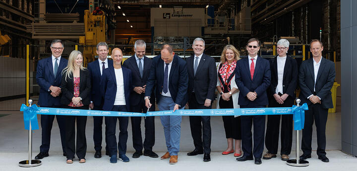 Matt Farnsworth cuts the ribbon to open the COMPASS facility