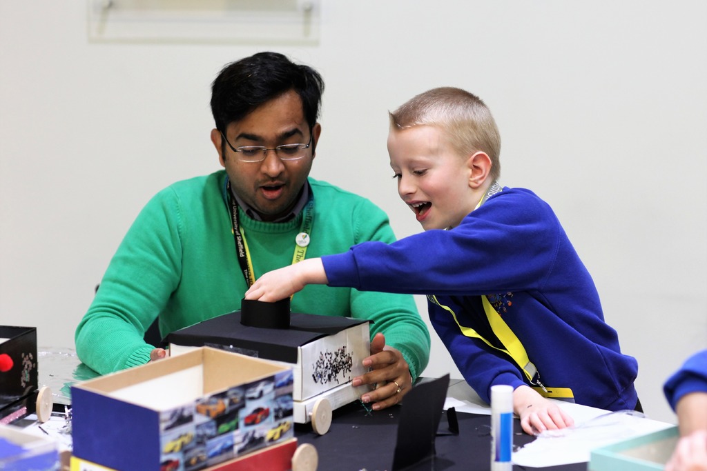 One of the pupils from Dinnington Community Primary works on his engineering skills building and decorating a shoebox car with AMRC STEM Ambassador and Great British Bake Off winner Rahul Mandal.