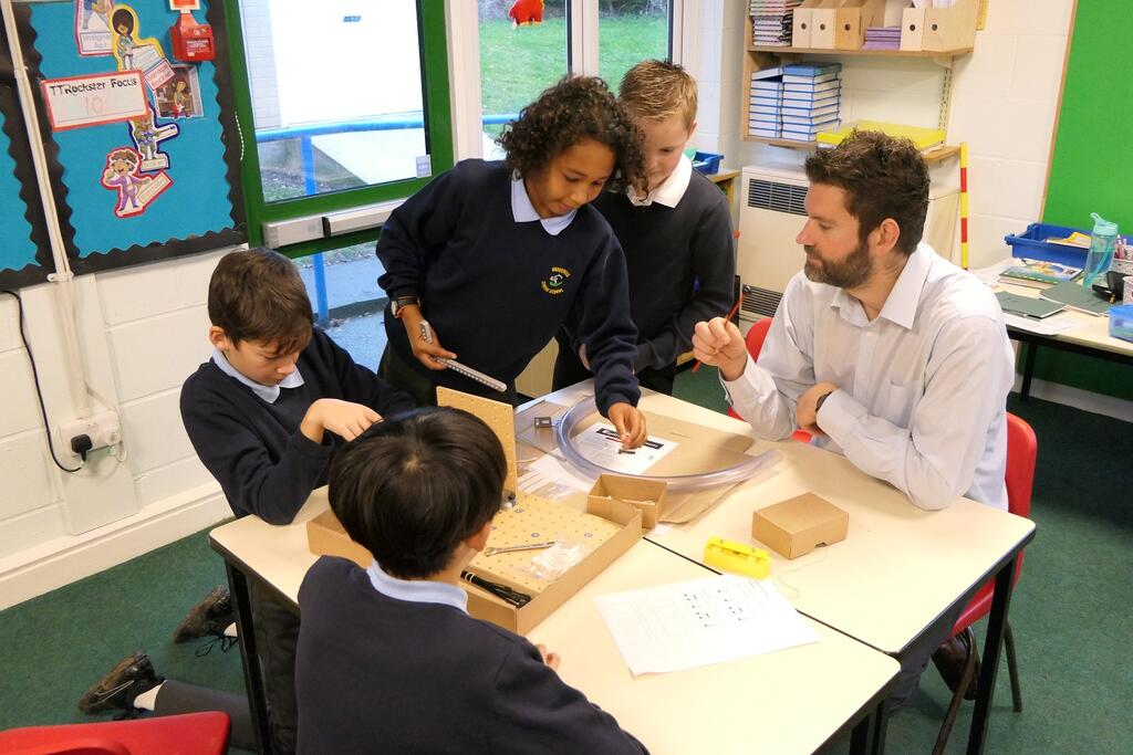 Teacher Wil Baker working with his STEM Club students.