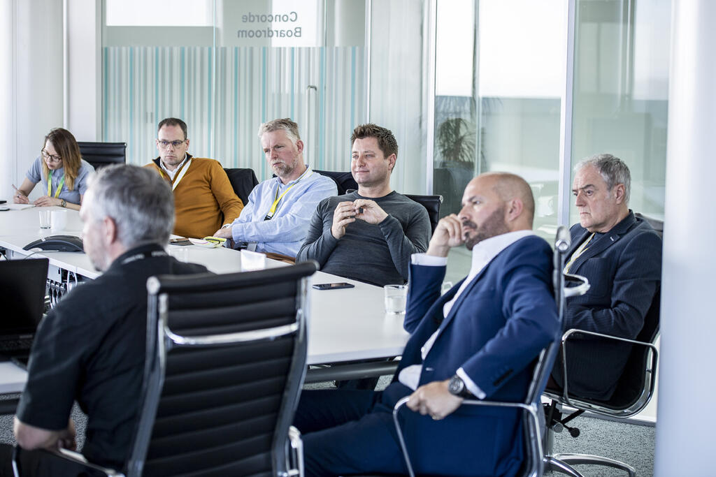 George Clarke, Mark Farmer and other members of MOBIE listeninging to AMRC CEO Colin Sirett talking about the centre's strong links with the University of Sheffield and industry.