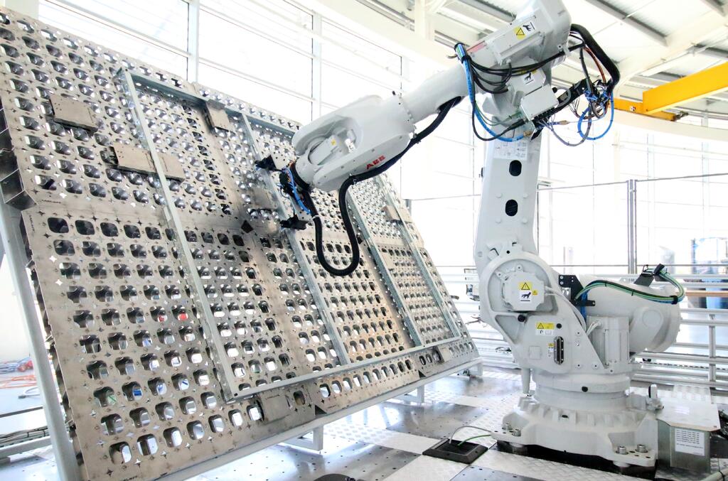 The Reconfigurable Factory Demonstrator cell which shows the robot proposed for the project on the AMRC’s custom reconfigurable floor to which the rotary table and fixture will be mounted. 