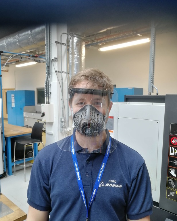 Daniel Tomlinson, Project Engineer at the AMRC Design and Prototyping Group, wearing one of the finished face visors. 