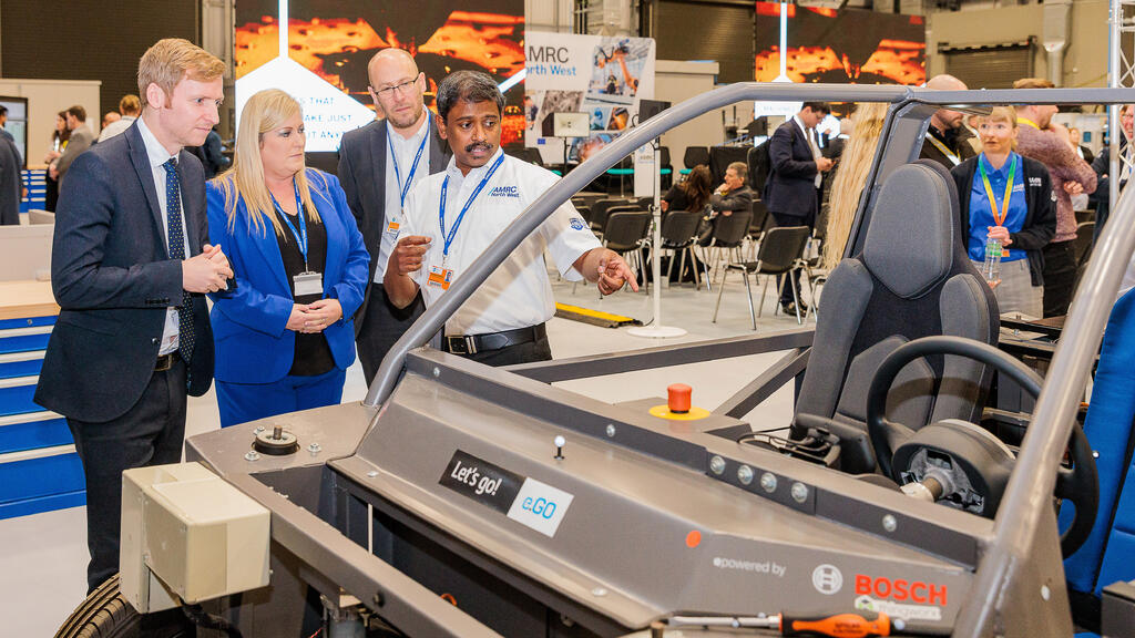 AMRC North West's head of digital technology, Aparajithan Sivanathan (R), showing Lee Rowley MP (L) some of AMRC North West's innovative technology