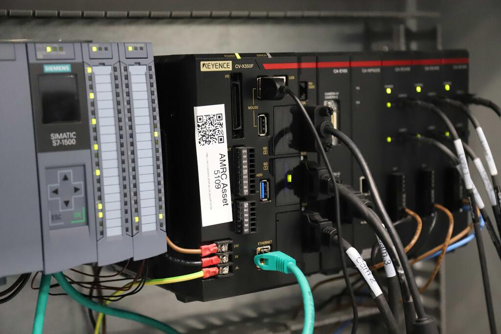 The programmable logic controller (PLC) is an IoT device which monitors and controls factory applications at AMRC North West, such as industrial robots.